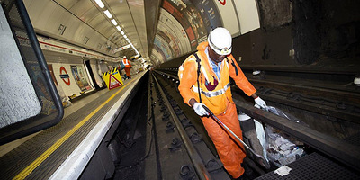 Transport for London Tube engineer, removing dust from the tracks at Tottenham Court Road Tube station