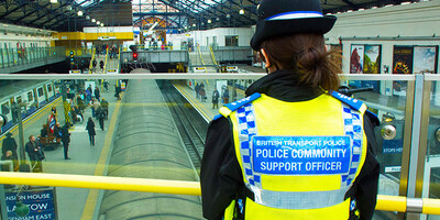 A Police Community Support Officer watches over a station concourse